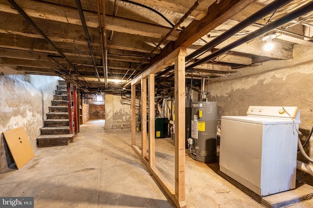 unfinished basement with stairway, washer / clothes dryer, and water heater