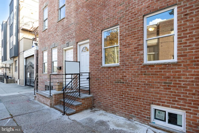 view of exterior entry with brick siding