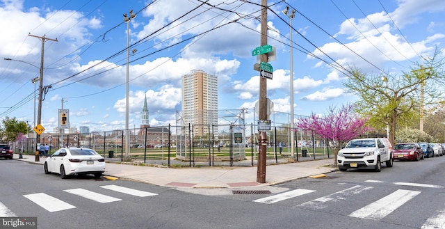 view of road featuring sidewalks, curbs, and traffic signs