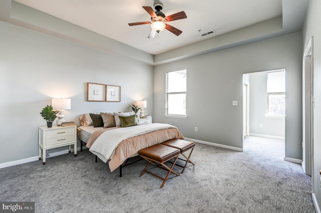 bedroom with carpet flooring, visible vents, baseboards, and ceiling fan