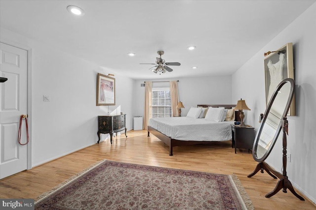 bedroom with baseboards, recessed lighting, a ceiling fan, and light wood-style floors