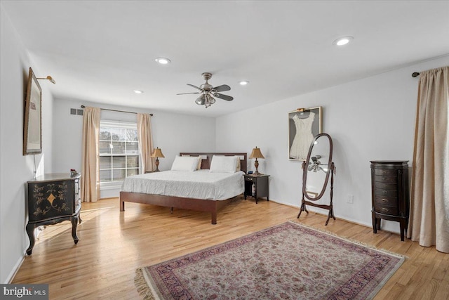 bedroom featuring recessed lighting, wood finished floors, visible vents, and baseboards