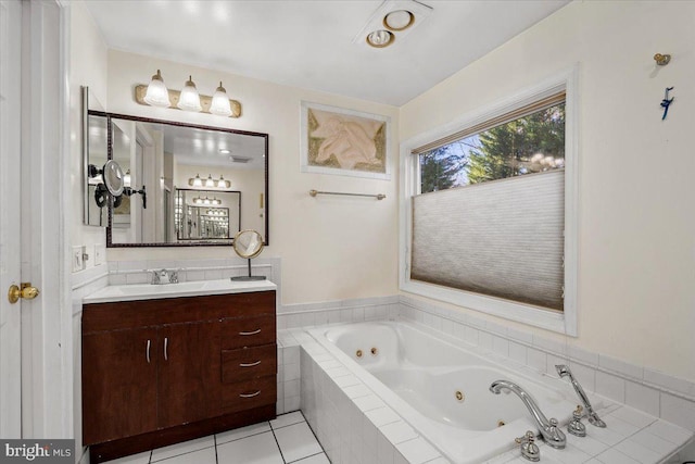 bathroom featuring vanity, tile patterned floors, and a tub with jets