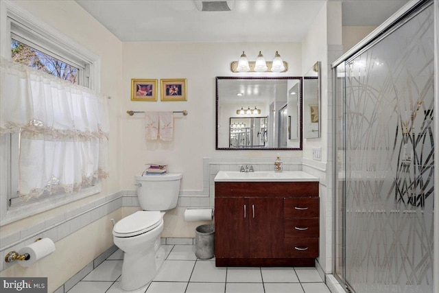 full bath with tile patterned flooring, a stall shower, toilet, and vanity