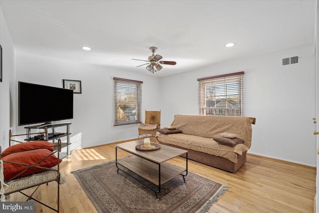 living area featuring light wood-type flooring, visible vents, a healthy amount of sunlight, and recessed lighting