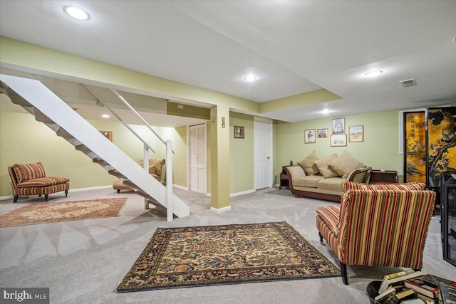 living area featuring visible vents, baseboards, stairway, carpet floors, and recessed lighting