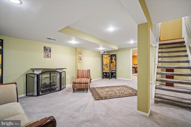 living room featuring visible vents, baseboards, stairs, and carpet