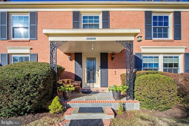 entrance to property with brick siding