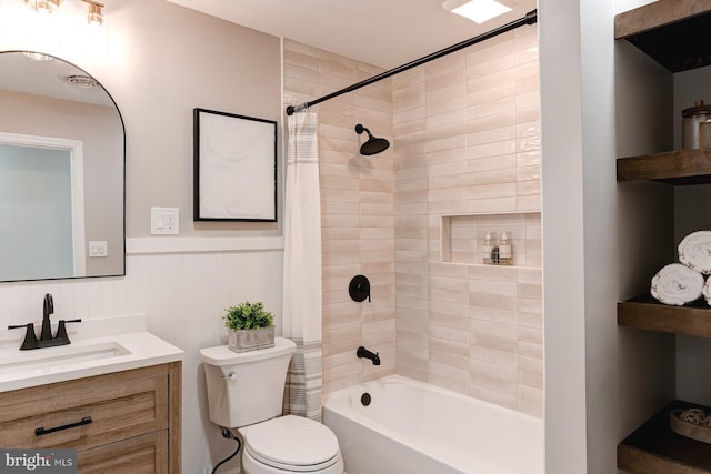 bathroom with vanity, shower / tub combo, and toilet