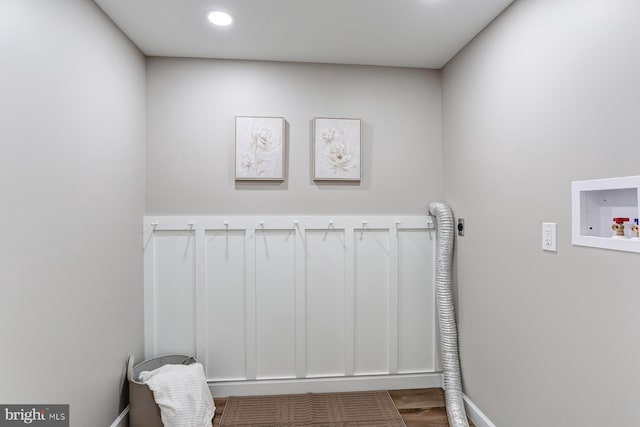 clothes washing area featuring baseboards, washer hookup, laundry area, wood finished floors, and hookup for an electric dryer