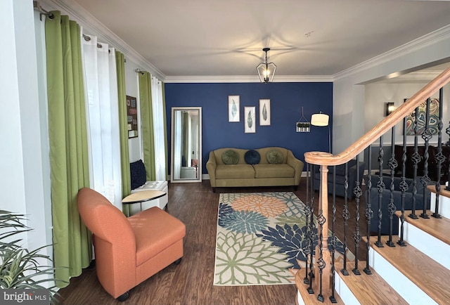 living area with crown molding, stairway, and wood finished floors