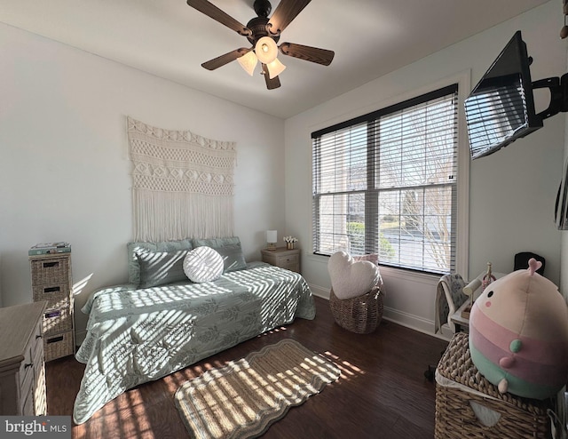 bedroom with dark wood-type flooring, baseboards, and ceiling fan