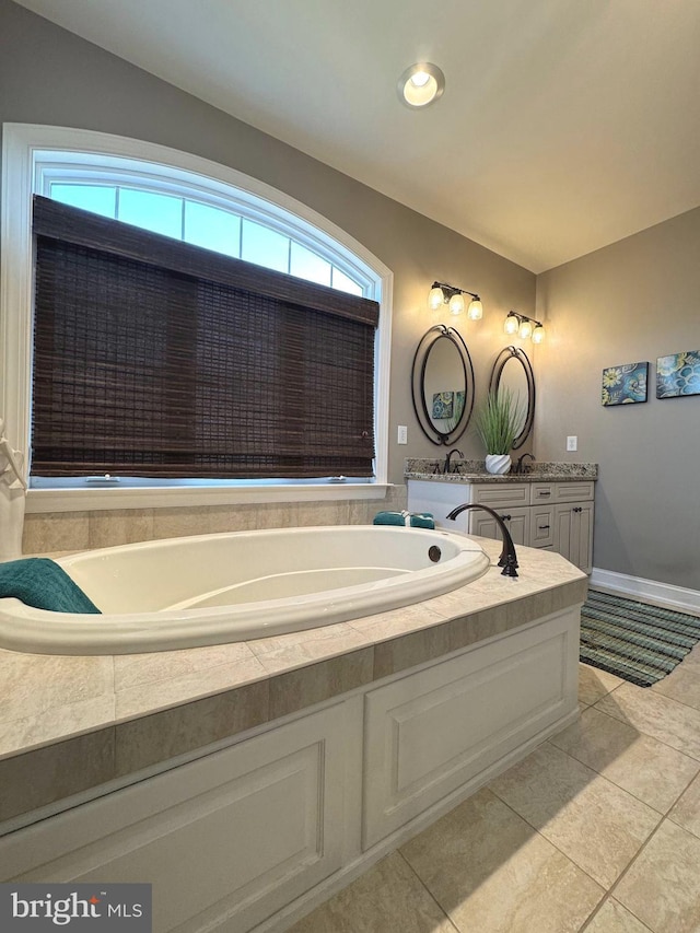 full bath with vanity, a garden tub, baseboards, and tile patterned floors