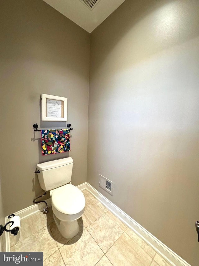 bathroom featuring visible vents, baseboards, toilet, and tile patterned flooring