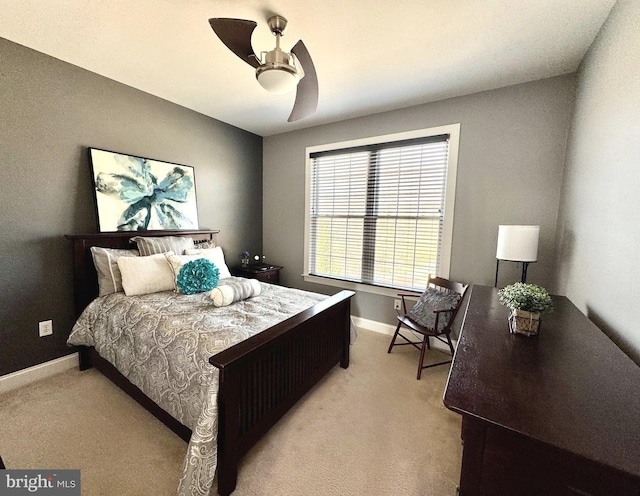 bedroom featuring ceiling fan, baseboards, and light carpet