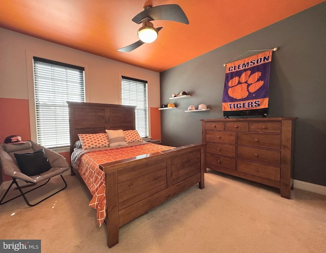 bedroom featuring ceiling fan, baseboards, and light carpet