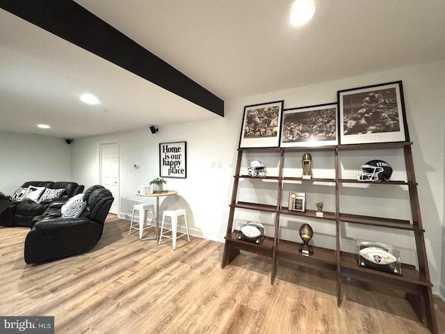 interior space featuring recessed lighting, baseboards, beam ceiling, and wood finished floors