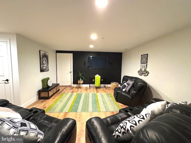 living room with recessed lighting, baseboards, and wood finished floors