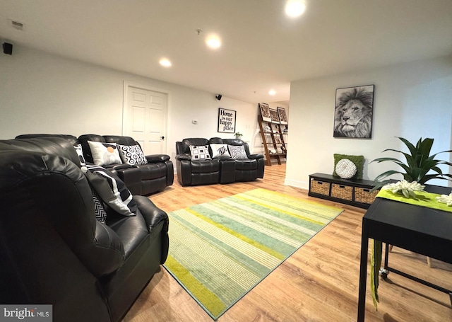 living room with recessed lighting and wood finished floors