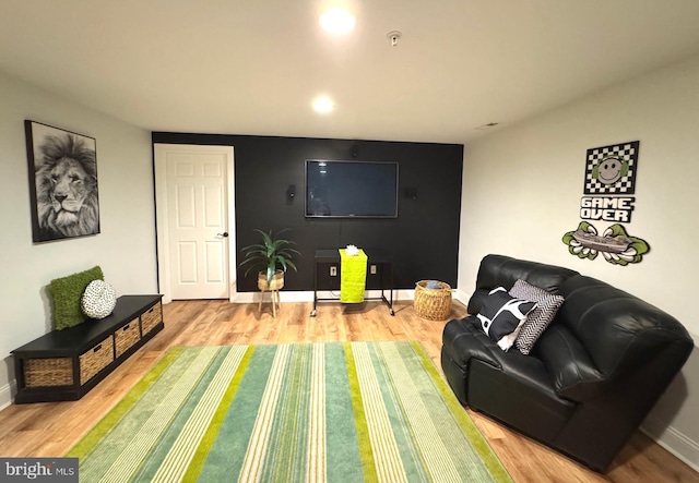 living room featuring recessed lighting, baseboards, and wood finished floors