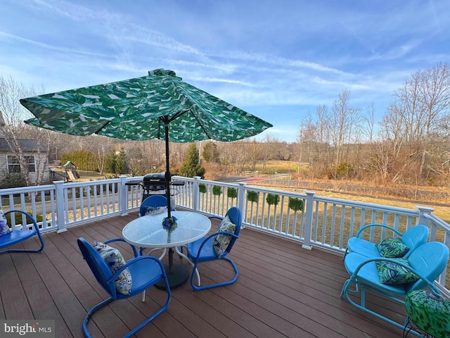 wooden terrace featuring a grill