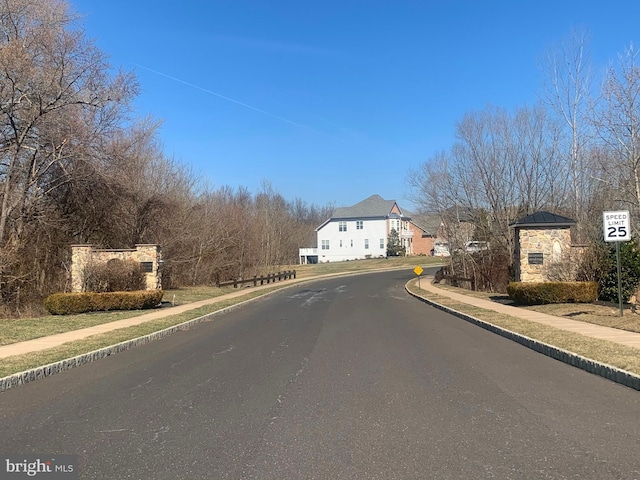 view of street with sidewalks, curbs, and traffic signs