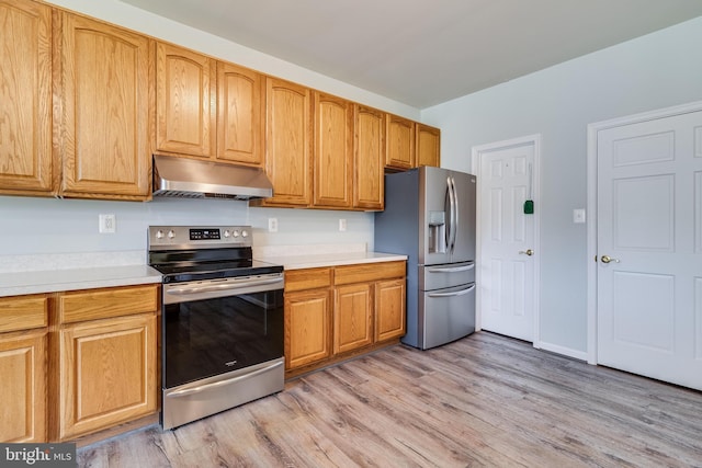 kitchen featuring light countertops, appliances with stainless steel finishes, light wood-style floors, and under cabinet range hood