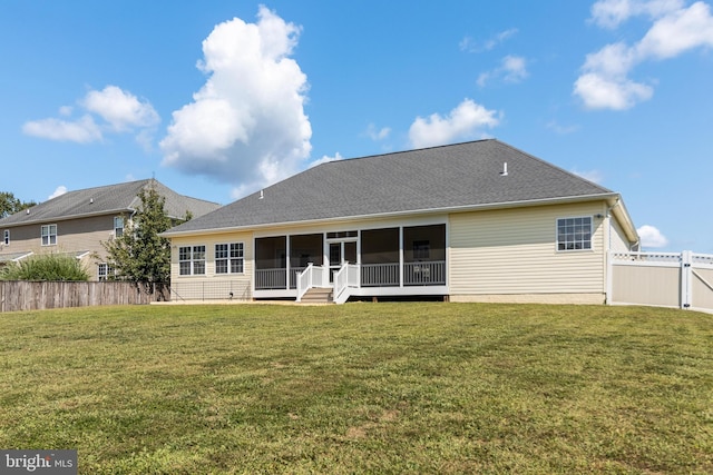 rear view of property featuring a lawn, a shingled roof, a fenced backyard, and a sunroom