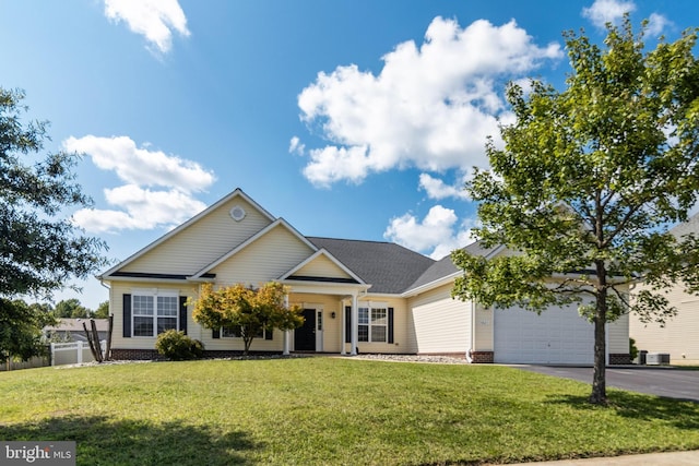 view of front of house featuring aphalt driveway, a front yard, an attached garage, and fence