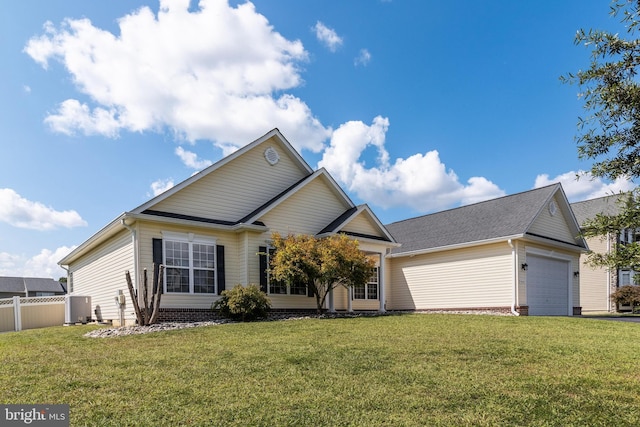 view of front of property with a front yard, an attached garage, and fence