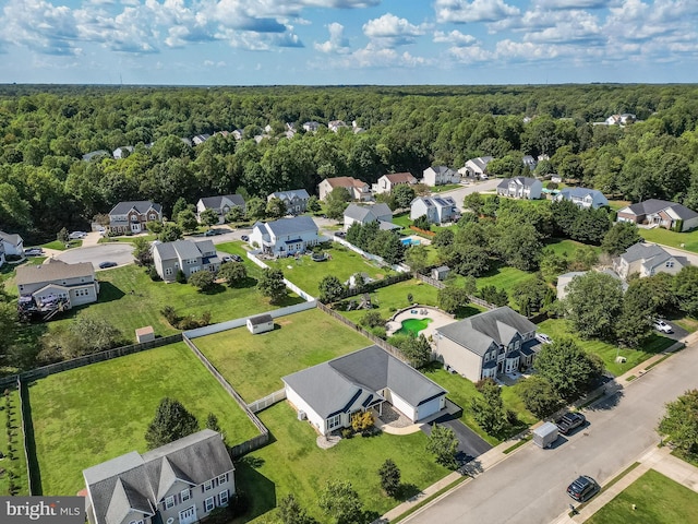 bird's eye view featuring a wooded view and a residential view