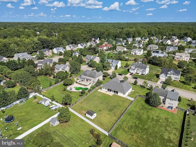 bird's eye view featuring a wooded view and a residential view