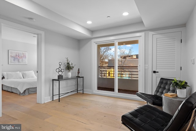 sitting room with recessed lighting, baseboards, and light wood finished floors