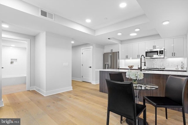 dining area with recessed lighting, visible vents, baseboards, and light wood finished floors