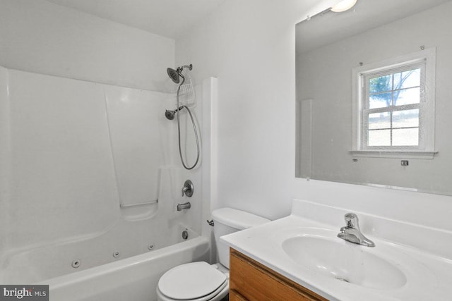 bathroom with tub / shower combination, toilet, and vanity