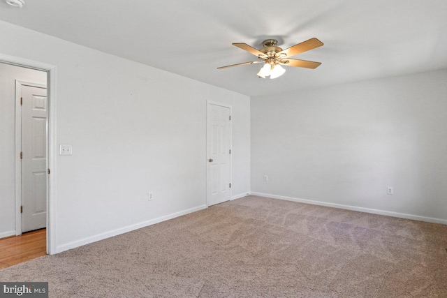 unfurnished room featuring light carpet, baseboards, and ceiling fan