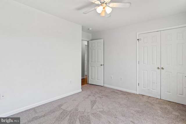 unfurnished bedroom with a closet, baseboards, carpet, and a ceiling fan