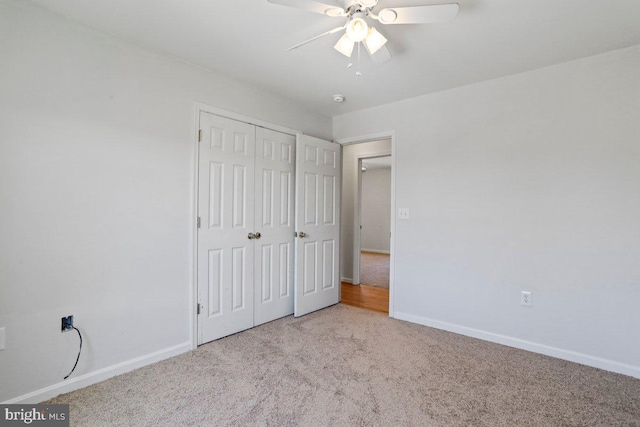 unfurnished bedroom featuring a closet, carpet flooring, a ceiling fan, and baseboards