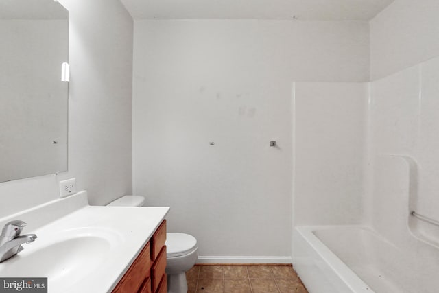 bathroom with baseboards, toilet, vanity, and tile patterned flooring