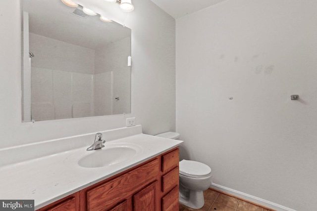 bathroom featuring vanity, visible vents, tile patterned flooring, a shower, and toilet