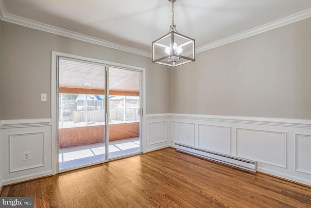 unfurnished dining area featuring a baseboard radiator, wood finished floors, and crown molding