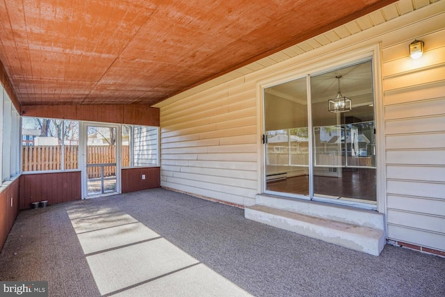 unfurnished sunroom featuring plenty of natural light, wooden ceiling, and vaulted ceiling