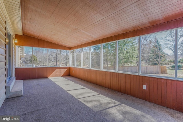 unfurnished sunroom with a wealth of natural light, wooden ceiling, and lofted ceiling