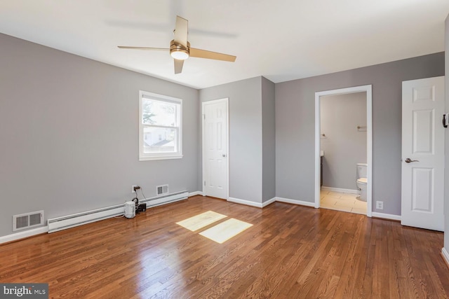 unfurnished bedroom with visible vents, connected bathroom, baseboards, wood finished floors, and a ceiling fan