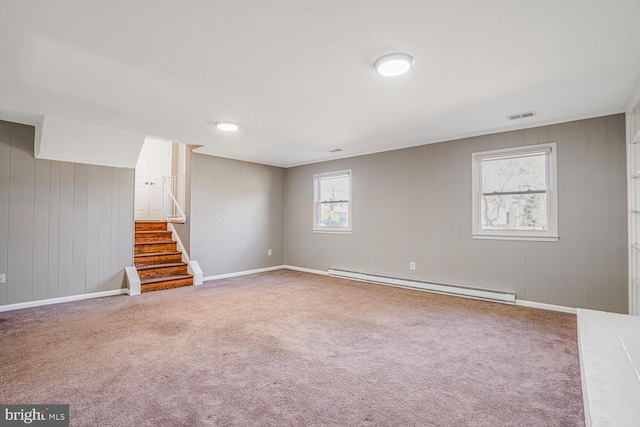 below grade area with stairway, carpet, visible vents, and a baseboard radiator