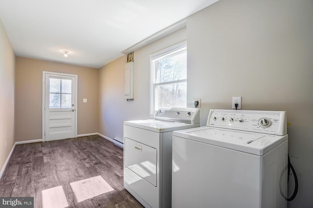 laundry room with independent washer and dryer, a baseboard heating unit, wood finished floors, baseboards, and laundry area