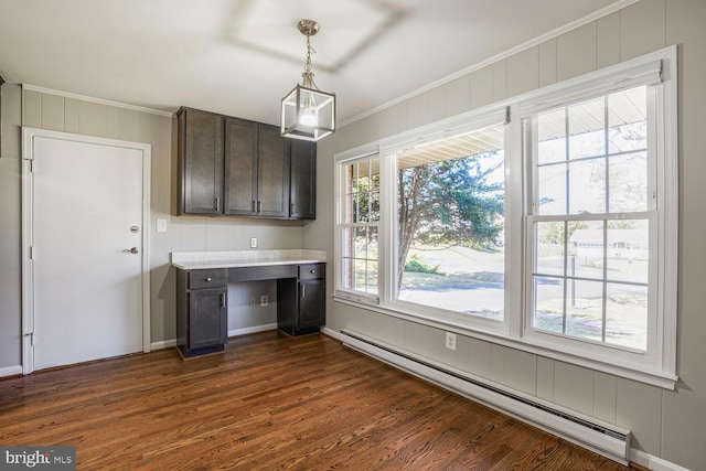 kitchen featuring crown molding, dark wood finished floors, dark brown cabinetry, light countertops, and baseboard heating