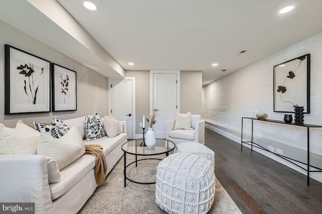 living area with recessed lighting, visible vents, baseboards, and wood finished floors