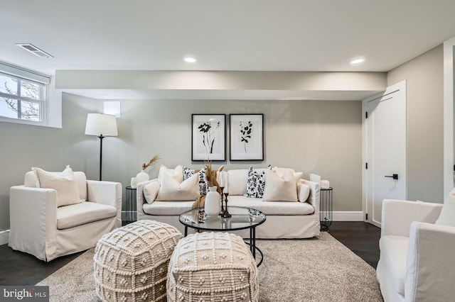 living room with recessed lighting, visible vents, baseboards, and dark wood-style floors