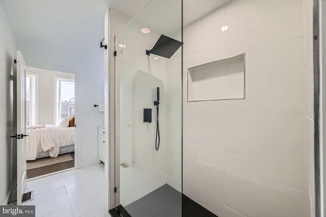 bathroom with a tile shower and connected bathroom